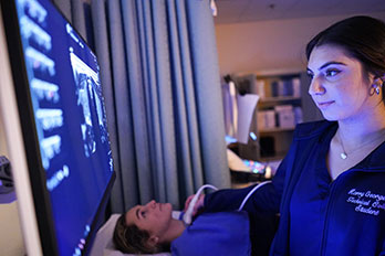a woman performs an ultrasound on a patient