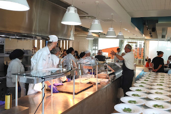 Chef James Porter instructs the culinary students for fundraising dinner.