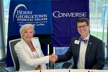 Dr. Marilyn Murphy Fore (left), HGTC President, and Dr. Boone Hopkins (right), Converse University President, shake hands during the signing of the agreement.