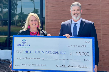 Mr. Jon Craig Howell presents a $25,000 check from the Ocean View Memorial Foundation to Shannon Detzler with the HGTC Foundation.