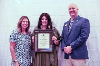 Savannah Rabon (center), HGTC Marketing Coordinator and Graphic Designer, receives her Leadership Conway diploma at the graduation ceremony from Becky Hubbard (left), Conway Chamber Immediate Past President, and Le Hendrick (right), Conway Chamber Vice President for Educational Programs